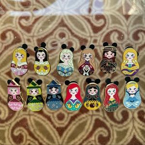 Disney Russian nesting dolls pin set- authentic. Comes with all 13 pictured